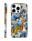 A phone case featuring photo art of multiple blue butterflies on textured grass, shown from both the side and back angles. The word INTENTION appears at the bottom of the case.