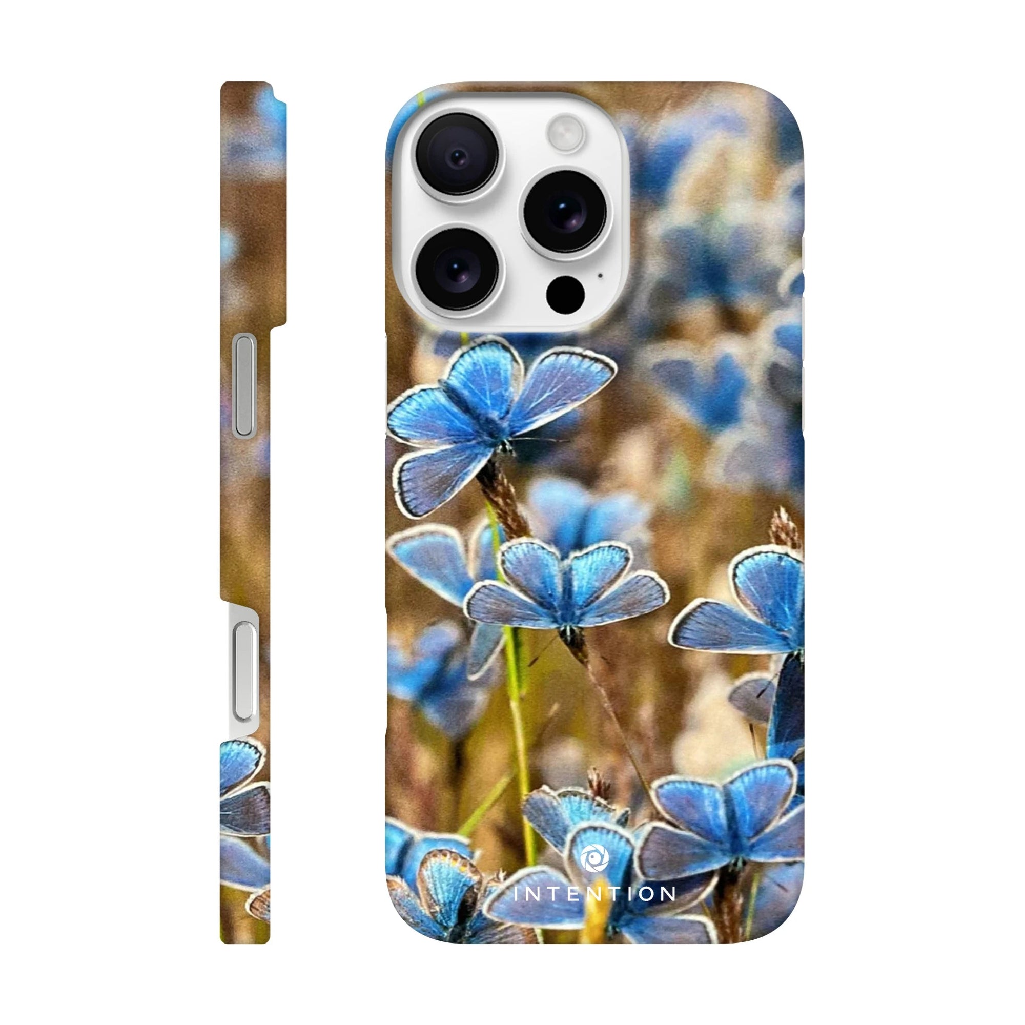 A phone case featuring photo art of multiple blue butterflies on textured grass, shown from both the side and back angles. The word INTENTION appears at the bottom of the case.