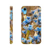 A phone case featuring photo art with a close-up image of blue butterflies on flowers, showcasing beautiful textures from back and side angles. The word INTENTION is printed near the bottom on the back of the case.