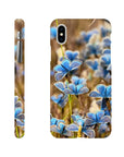 A phone case featuring a close-up photo art image of blue butterflies perched on grass and flowers in a natural setting. Textures and the word INTENTION appear near the bottom of the case.