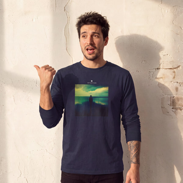 Calm - "Emerald Storms" French Navy Long Sleeve worn against a sunlit plaster wall