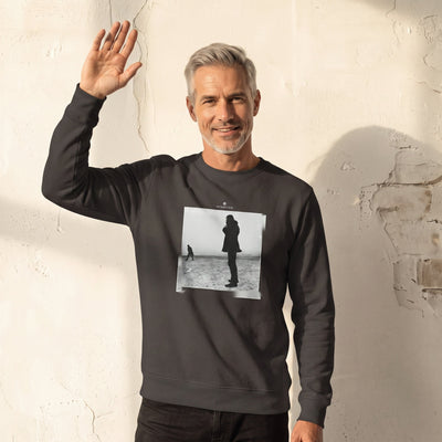 Compassion - "The Space We Share" deep charcoal grey Sweatshirt worn against a sunlit plaster wall