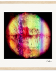 A close-up of lips with a textured surface and bright rainbow streaks on a black background, set in a wood frame—ideal as vibrant wall art to inspire any conscious interior design.