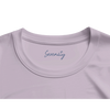 A close-up of the neckline of an organic lavender t-shirt, featuring the word Serenity printed inside the collar in blue cursive—an elegant detail for conscious fashion lovers.