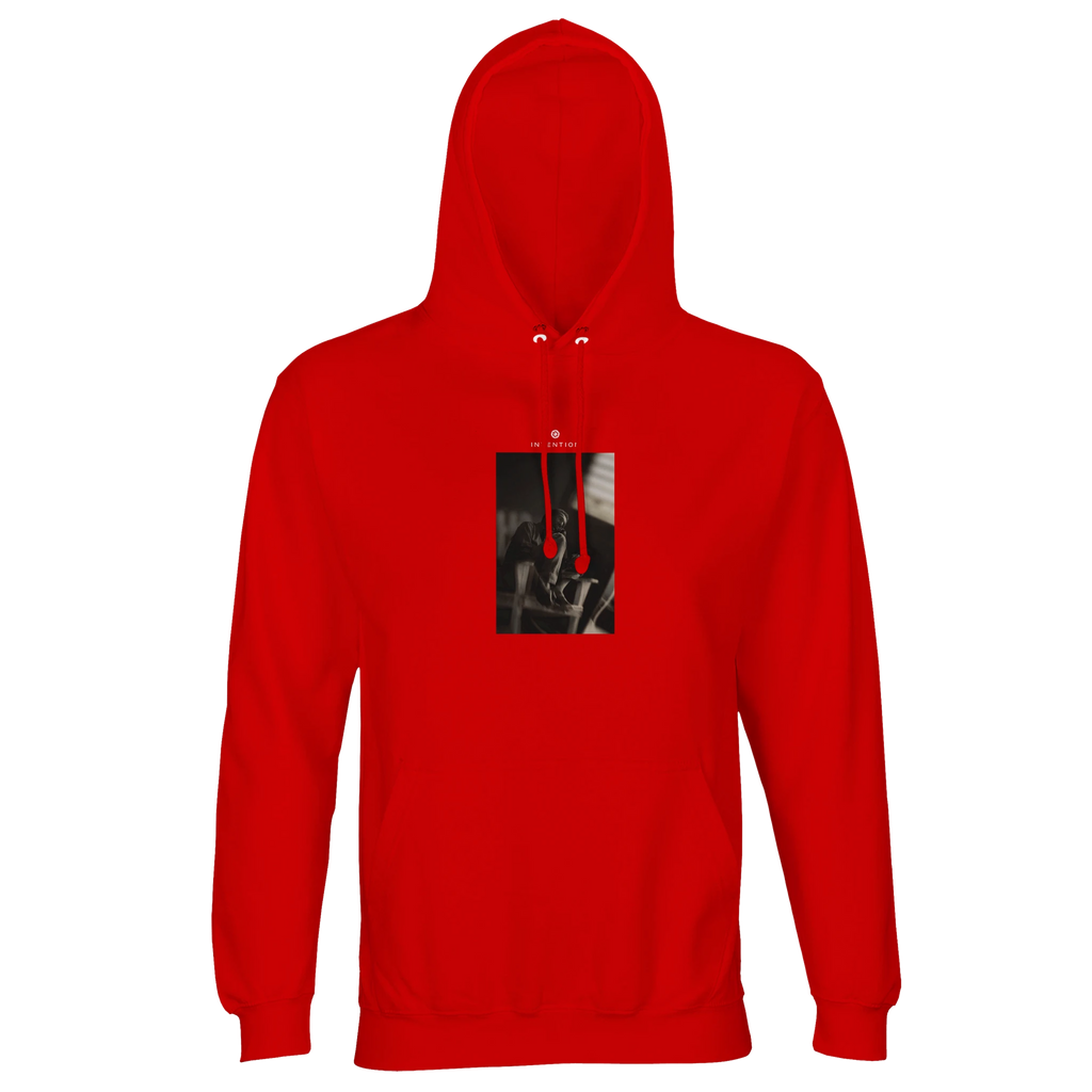 A bright red hooded sweatshirt with a front pocket and an abstract black and white art print on the chest features red drawstrings. Made from organic material, it's shown on a plain white background.