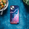 A smartphone with a blue and pink marbled case labeled INTENTION lies on a blue surface. This photo art captures unique textures, with pasta on one side and leafy greens on the other—perfect as an art print.