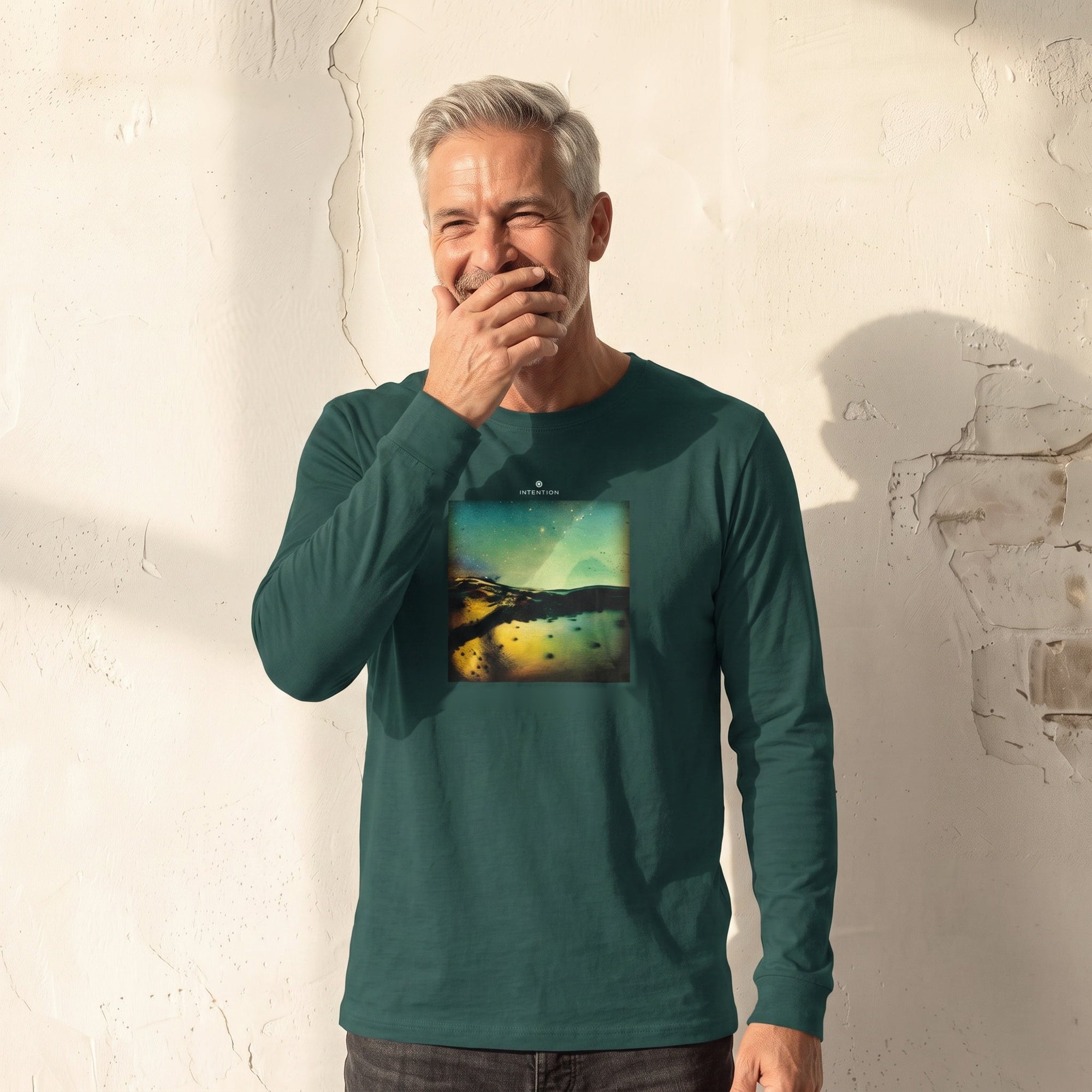 Harmonious - "Underwater Flight" green empire Long Sleeve worn against a sunlit plaster wall