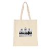 A natural tote bag made from organic material, featuring a black and white art print of a person walking past another sitting outside a building, with the word INTENTION printed above the image.