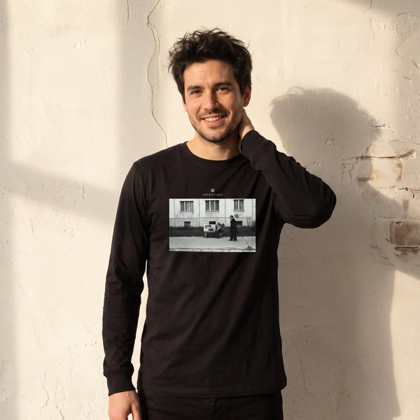 Oneness - "The Urban Matrix" Deep Black Long Sleeve worn against a sunlit plaster wall