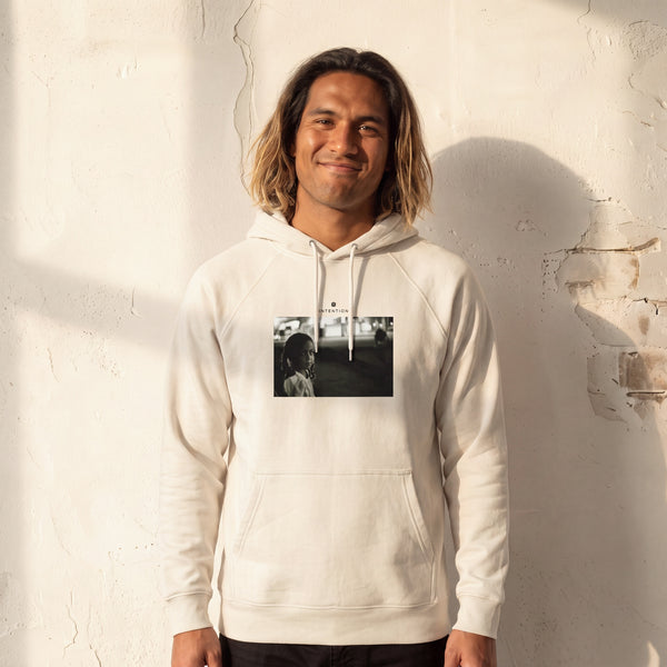 Presence - "Cuba Girl" Off White Hoodie worn against a sunlit plaster wall