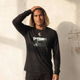 Presence - "Cuba Girl" Deep Black Long Sleeve worn against a sunlit plaster wall