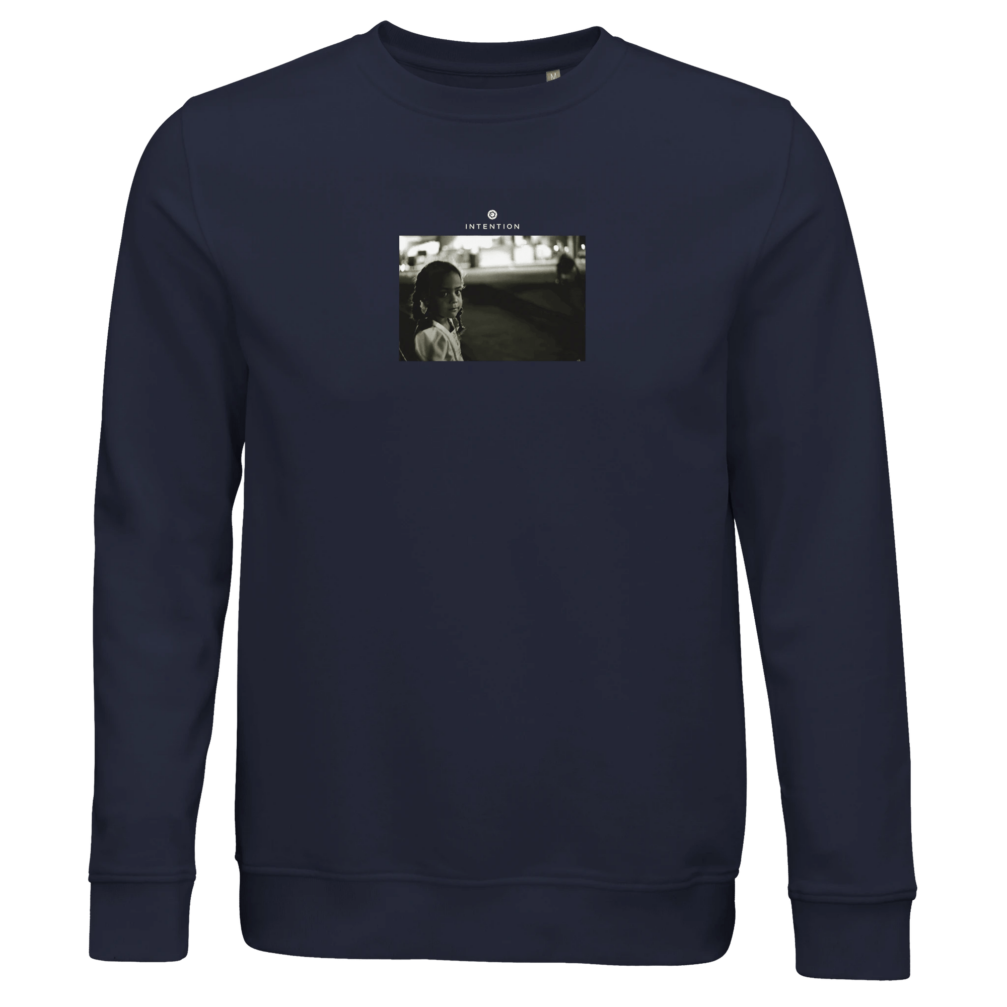 A French Navy sweatshirt featuring a small, centered black-and-white photo print on the chest of a person outdoors at night, with text above the image for a bold, thoughtful fashion statement.