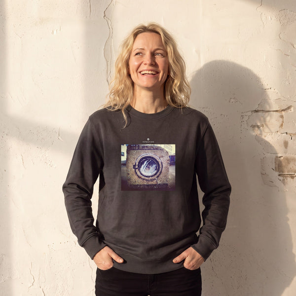 Resilience - "Wash It" deep charcoal grey Sweatshirt worn against a sunlit plaster wall