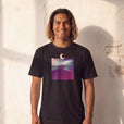 Serenity - "Indigo Sky" Deep Black T-shirt worn against a sunlit plaster wall