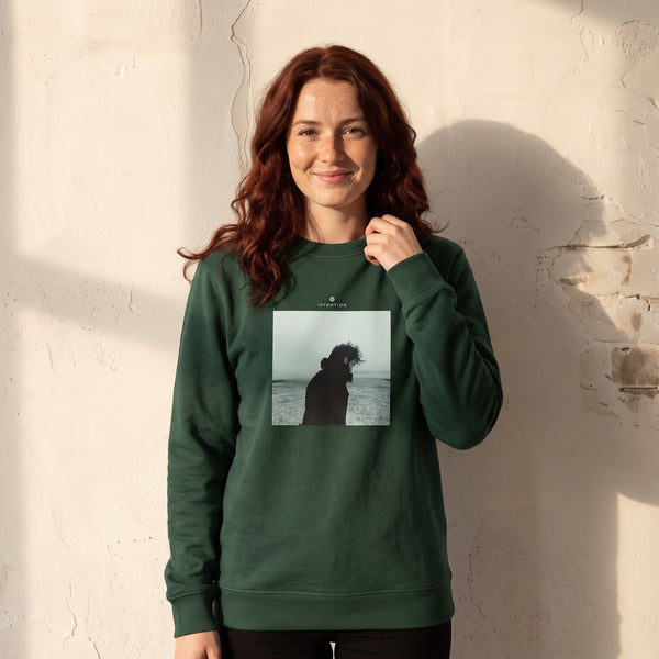 Strength - "Misty Mind" Bottle Green Sweatshirt worn against a sunlit plaster wall